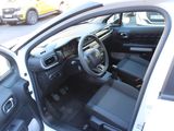 the interior of a car with the door open and the driver ' s seat down