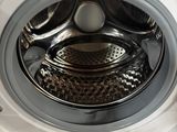 a close up of a washing machine with the door open