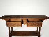 an old wooden table with two drawers on top of it