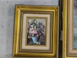 two framed pictures of flowers in a vase on the wall