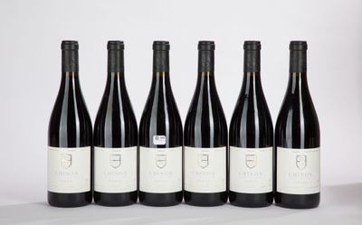 six bottles of wine are lined up on a table
