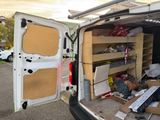 a white van that has a bunch of boxes in the back of it