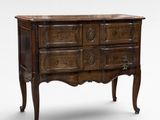 an antique chest of drawers with carved wood and marble top