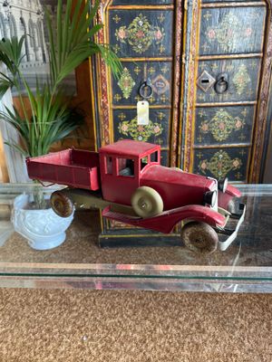 a red toy truck sitting on a glass coffee table