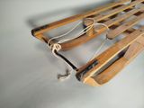 a wooden sled with a rope attached to it