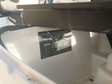 a close up of a white toilet with a tag on it