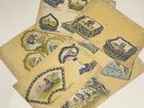 several pieces of paper with different designs on them sitting on a table