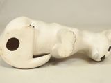 porcelain figurine of a cat laying down on its side