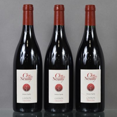 three bottles of red wine are lined up on a table