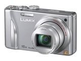 a silver camera that is sitting on a white surface