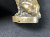 pair of antique brass dog figurines on a black background