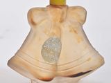 a small glass bell with a gold bell on it