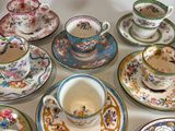 a lot of tea cups and saucers sitting on a table