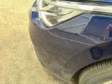 a close up of a car ' s headlight and front bumper