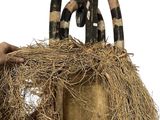 a person that is holding a straw bag with horns on it