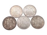 six different british coins are shown in a row on a white background