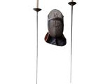 a statue of a man with a sword and a candle holder