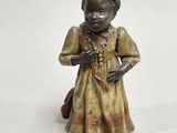 figurine of a little girl with a bag and a purse