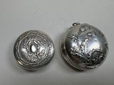 two silver lockes sitting next to each other on a table