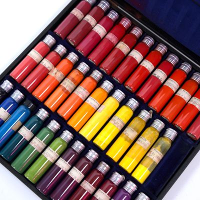 many different colors of paint in a black box