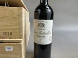 a bottle of wine sitting next to a wooden box