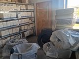 a room with a lot of boxes and bags on the floor
