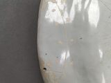 a white toilet with a rusted rim and a white seat