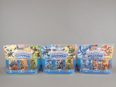three packs of skyla battle figures in plastic bags on a gray surface