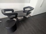 two black chairs sitting next to each other in a room