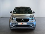 an image of a silver smart car parked in a showroom