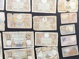 a bunch of old paper money sitting on top of a table