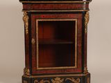 an antique black and gold painted cabinet with a marble top