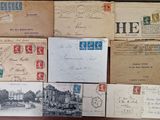 several old postcards and envelopes on a wooden table
