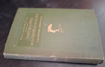 a green book sitting on a table on the table