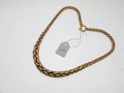 a close up of a gold necklace with a tag on it