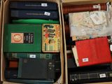 many books in a box with labels on them