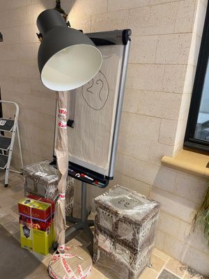 a lamp that is sitting on a table in the corner of a room