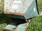 a man standing next to a dumpster in a field