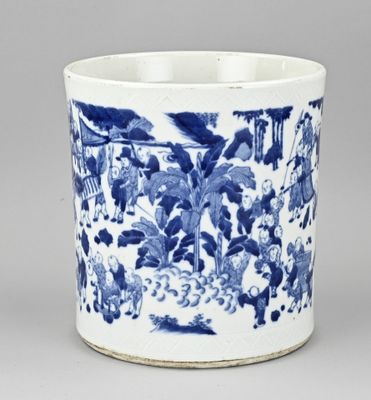 a blue and white cup with a picture of people in a garden