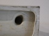 a white sink with a hole in the middle of it