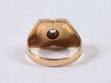 a close up of a gold ring with a brown diamond
