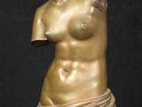 statue of a female nude torsoed figure on a marble base