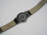 a watch that is sitting on a white surface