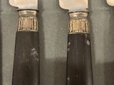 four knives that are sitting on a table