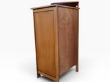 an image of a small wooden cabinet with a door
