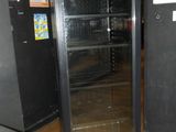 an image of a glass door refrigerator in a kitchen