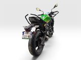 a green and black motorcycle parked on a white surface