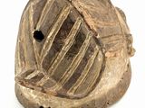 an old wooden object with a hole in the middle of it