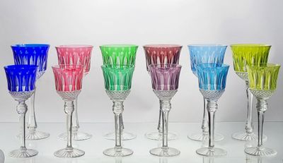 several different colored wine glasses are lined up on a table