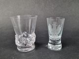 two shot glasses sitting next to each other on a table